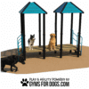 Three dogs play on and around the Social Play Series - Cafe 24, a raised agility structure with two blue-roofed sections. The tan ground features the caption: “Play & Agility Powered by Gyms for Dogs.com.”.