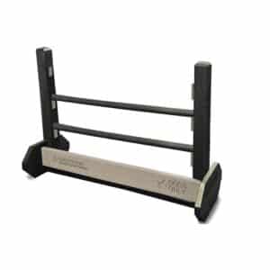 The Jump Hurdle - Adjustable Portable Mount is a black and gray dog agility obstacle with three horizontal bars and a base sign reading “DOGS ONLY,” perfect for any dog park.