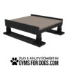 A black and brown Training Platform (L/X) with sturdy legs for play and agility is shown above "Play & Agility Powered by GymsForDogs.com" and a paw print graphic.