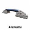 Ellie’s Boulder Bridge Pro features a textured blue walkway with two rock-like bases and bumper pads, ideal for any Dog Park. Text below states "Play & Agility Powered by GymsForDogs.com" alongside a paw print graphic.