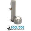 A stainless steel dog water fountain with a round basin and spout, next to a standing pipe and faucet. Below is the logo "COOL DOG WATER FOUNTAINS.COM" with a dog illustration.